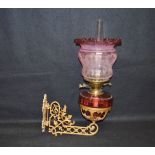 A Ruby Glass Oil Lamp, Ruby Shade on Gilted Metal Wall Bracket