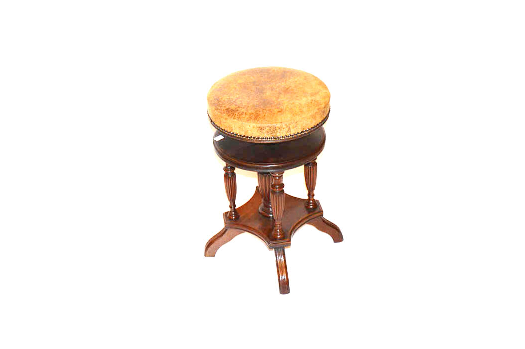 A Circular Mahogany Leather Covered Piano Stool