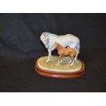 A Porcelain Figurine of a Horse and Foal