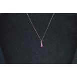 A 9ct White Gold Diamond, Ruby and Pink Sapphire Pendant, on a 9ct