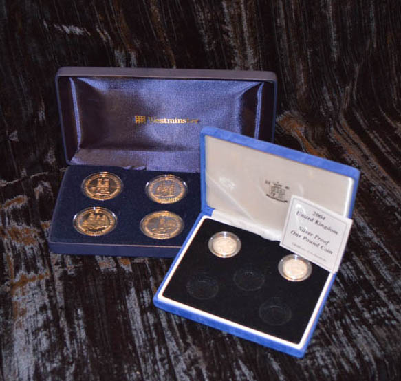 A Cased Royal Family Commemorative Coin Set and Two Silver Proof £1.00 Coins