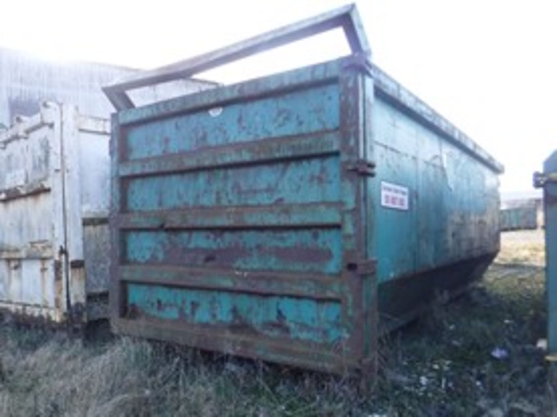 OPEN TOP SKIP.REAR DOOR HINGED AT RHS. H2100 L5800 W2300. SEVERAL PUNCTURE HOLES IN BODY. VIDEO OF A