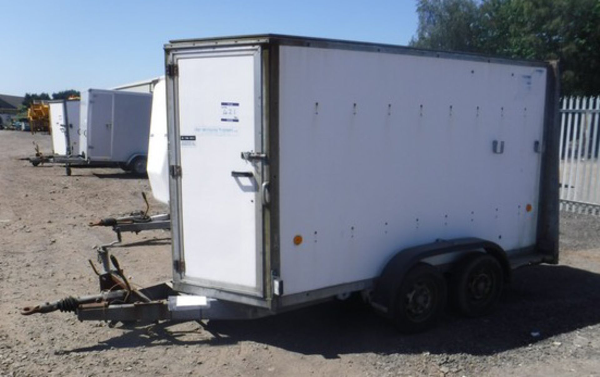 IFOR WILLIAMS 10' x 5' twin axle box trailer. Fitted with shelves, bench & power points. VIN - X0253