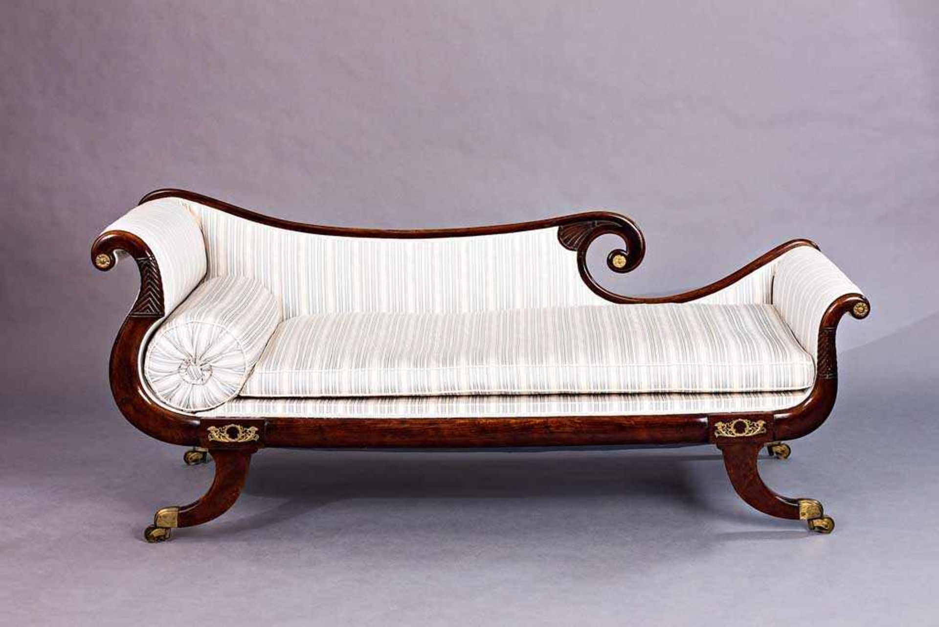 Regency-Chaiselongue auf Säulenbeinen in Bronzeschuhen auf Rollen. Gepolstert und bezogen. Mahagoni.