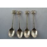 COLLECTABLES - A collection of 4 white metal teasp