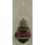 COLLECTABLES - An antique oil lamp with pink glass