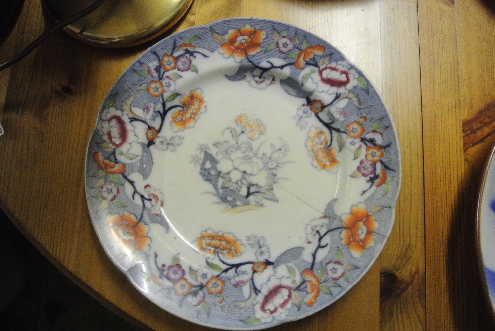 CERAMICS - An antique hand painted plate with unus