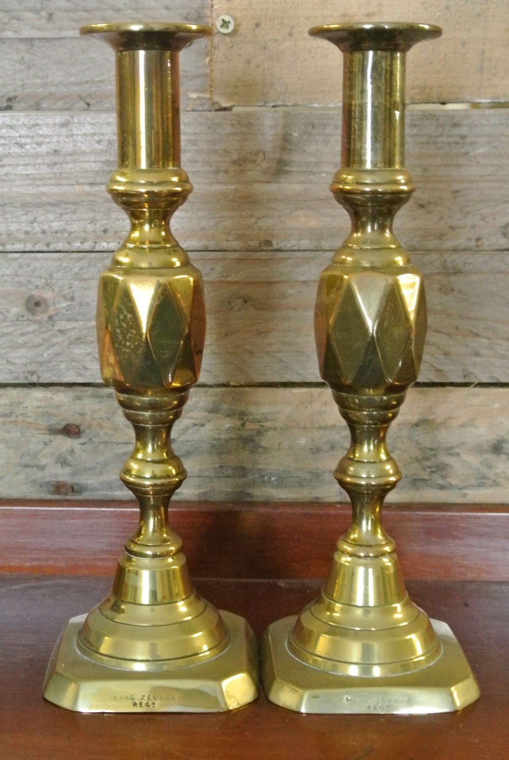 COLLECTABLES - A pair of antique brass candlestick