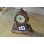 CLOCKS - An antique oak cased small mantle clock,