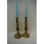 COLLECTABLES - A pair of antique brass candlestick