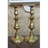 COLLECTABLES - A pair of antique brass candlestick