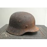 MILITARIA - A WW2 German helmet with bullet hole a