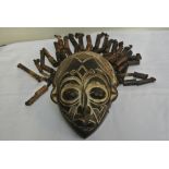 COLLECTABLES - A carved African mask with applied