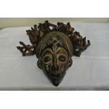 COLLECTABLES - A carved African mask with applied