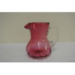 GLASS - An antique Ruby glass jug, measuring 10cm