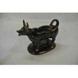 CERAMICS - A ceramic cow creamer jug with decorati