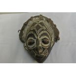 COLLECTABLES - A carved African mask with applied