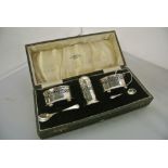 SILVER - A cased sterling silver cruet set to incl