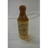 COLLECTABLES - A vintage stoneware bottle reading