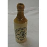 COLLECTABLES - A vintage stoneware bottle reading