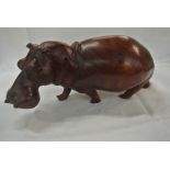 COLLECTABLES - A hand carved wooden hippo.