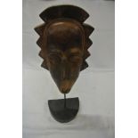 COLLECTABLES - A hand carved wooden mask on base,