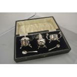 SILVER - A cased sterling silver cruet set to incl