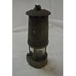 COLLECTABLES - An antique miners lamp with plaque