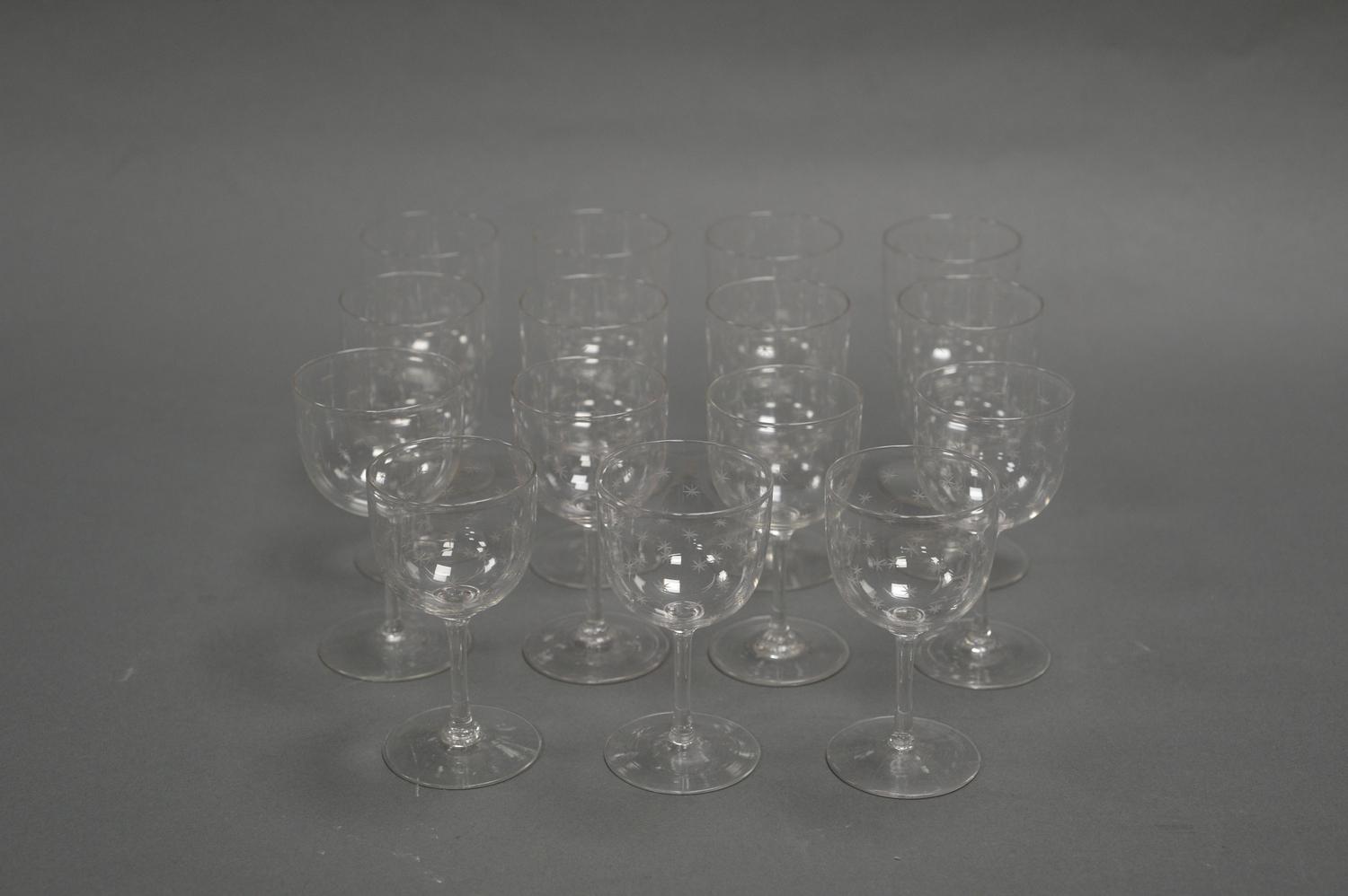 A SET OF FIFTEEN CRYSTAL SHERRY GLASSES. Each embellished with hand cut stars