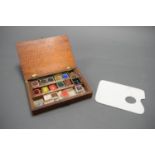 A SMALL ARTIST'S WATERCOLOUR BOX, WITH ASSOCIATED CERAMIC PALETTE. BELIEVED TO HAVE BEEN GIVEN AS