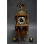 A REPRODUCTION ZAANSE CLOCK c 1960 with brass centre-piece depicting Faith, Hope and Charity, and