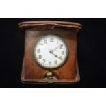 ANTIQUE LEATHER-CASED 8-DAY SWISS ALARM CLOCK.