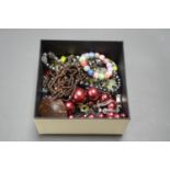 A BOX OF COSTUME JEWELLERY