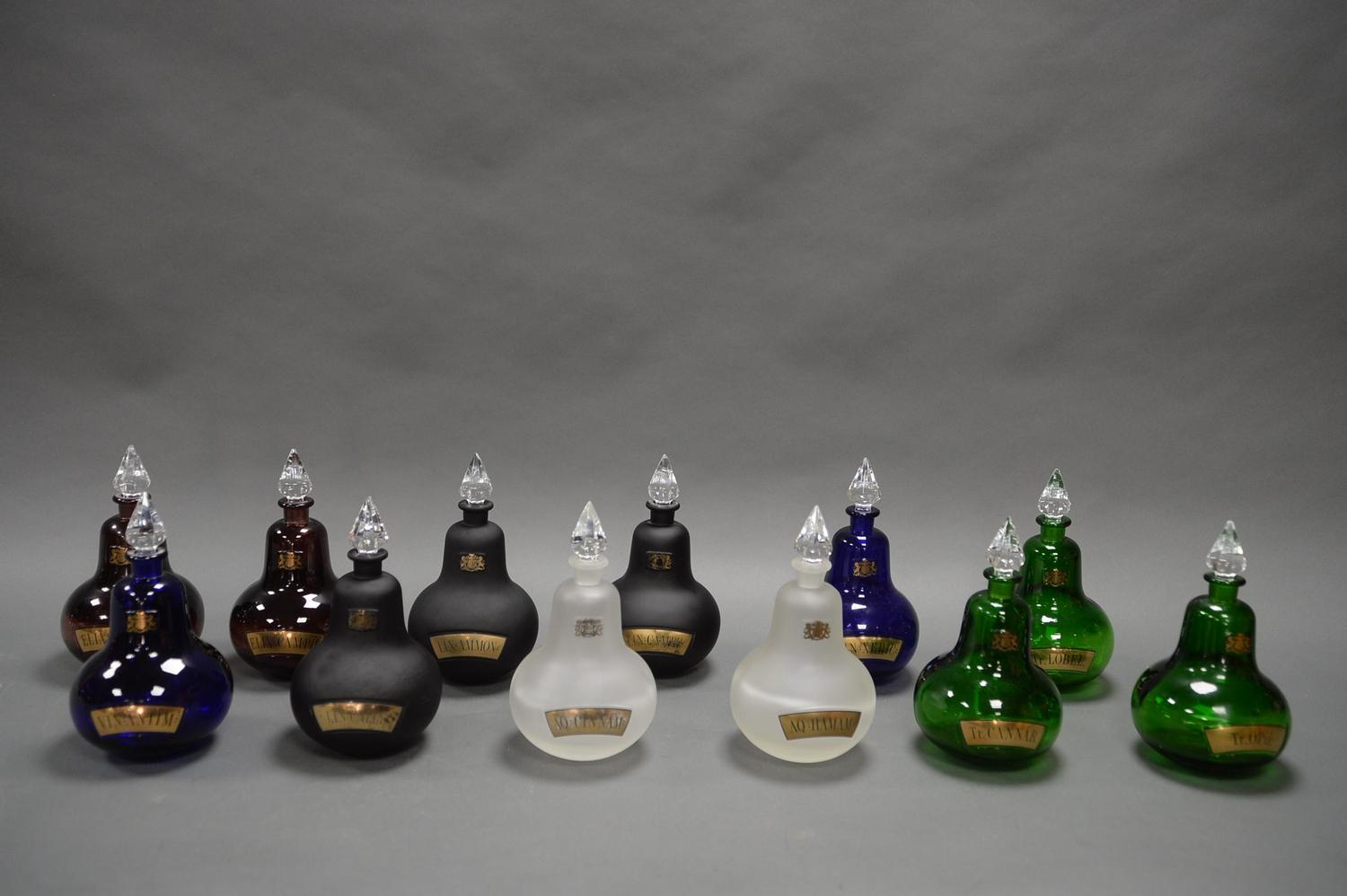 A COLLECTION OF TWELVE DECORATIVE APOTHECARY BOTTLES, WITH CRYSTAL STOPPERS. EACH MEASURING 24CM