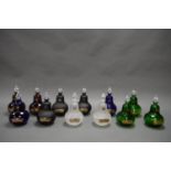 A COLLECTION OF TWELVE DECORATIVE APOTHECARY BOTTLES, WITH CRYSTAL STOPPERS. EACH MEASURING 24CM