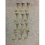 A COLLECTION OF 16 ANTIQUE BRASS COAT HOOKS