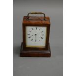 A WOODEN CASED CARRIAGE CLOCK WITH ENAMEL DIAL MARKED 'W. LISTER AND SON, PARIS". MOVEMENT MARKED