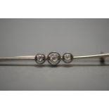 AN 18CT GOLD THREE DIAMOND BAR BROOCH. WEIGHT 4.1g