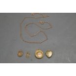 THREE PIECES OF 9CT GOLD, TWO LOCKETS AND A SWASTIKA CHARM, PLUS A FURTHER GOLD COLOURED PENDANT AND