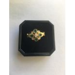 A 9CT GOLD RING SET WITH FOUR EMERALDS AND FIVE DIAMONDS. WEIGHT 2.5G, SIZE O