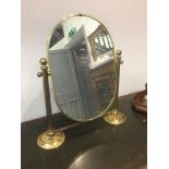 A TILTING MIRROR IN BRASS STAND, height 53cm