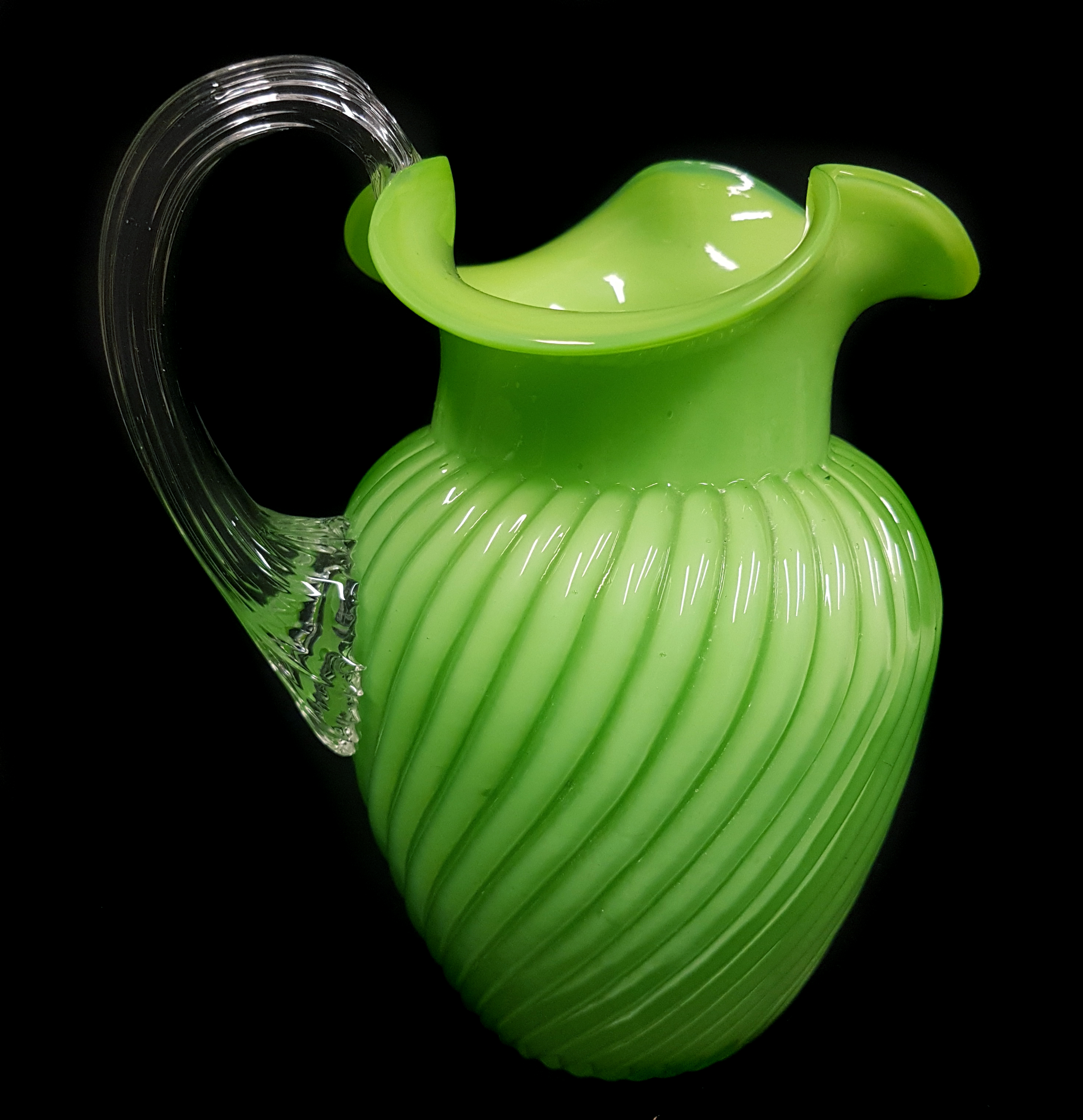 A Stourbridge cased and ribbed green glass jug, trefoil rim with colourless glass strap handle, 16cm