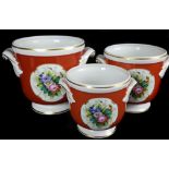 A graduated set of three Vista Alegre porcelain cache pots, painted with reserves of summer