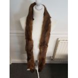 A four mink tippet, with head, feet and tails, woven toggle fastening, 240cm approx