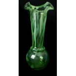A Scottish art glass vase, green with striated opaque inclusions trumpet neck on ball form feet