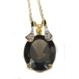 A chocolate topaz and diamond pendant set with two small diamond chips in 9ct yellow gold mount;