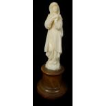 A Continental carved ivory figure probably Dieppe of the Repentant Magdelene, standing with hands