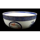 A continental porcelain bowl, decorated in Chinese Export porcelain style with baskets of flowers