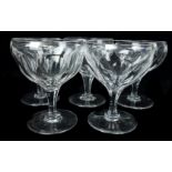 Five Webb coupe form glasses, the rounded bowls cut with foliate panelling, 12cm high (5)