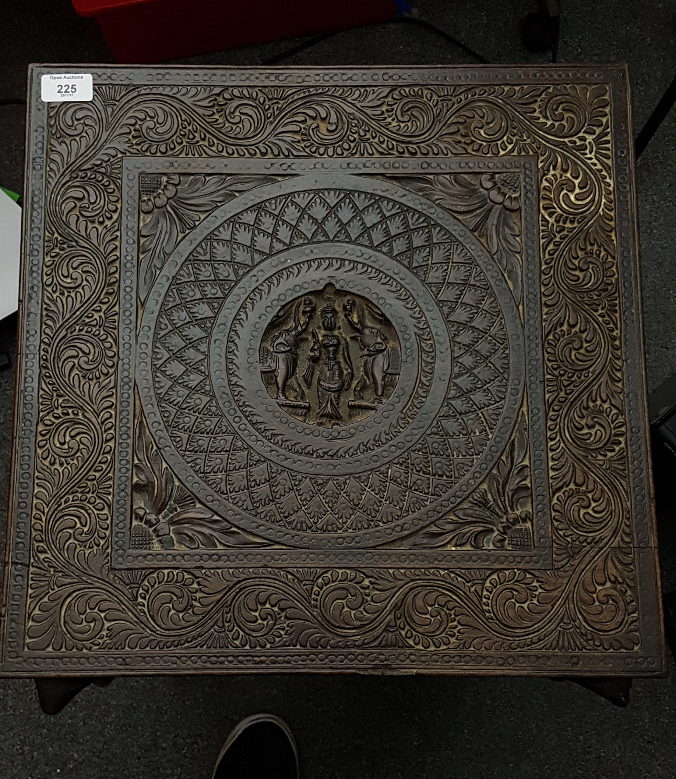 An Anglo-Indian carved hardwood table, the square topped table carved with central roundel of a